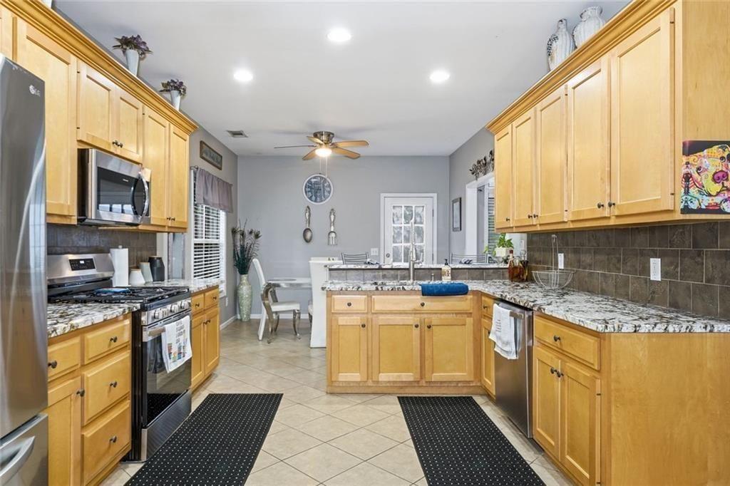 170 Sable Trace Trail Acworth, GA 30102 - Photo 18 of 48 a kitchen with stainless steel appliances granite countertop a stove a sink and a microwave