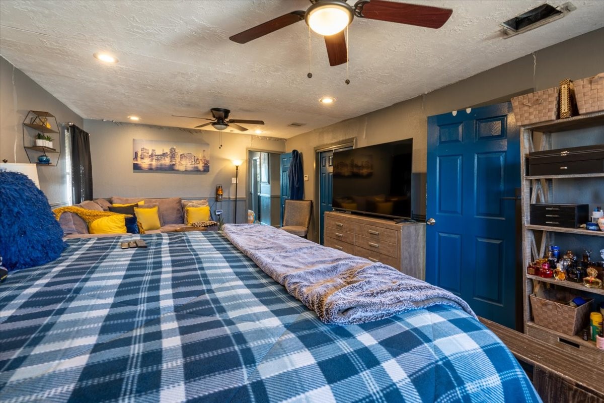 10601 Buffum Street Houston, TX 77051 - Photo 39 of 50 a bedroom with a bed and a flat screen tv