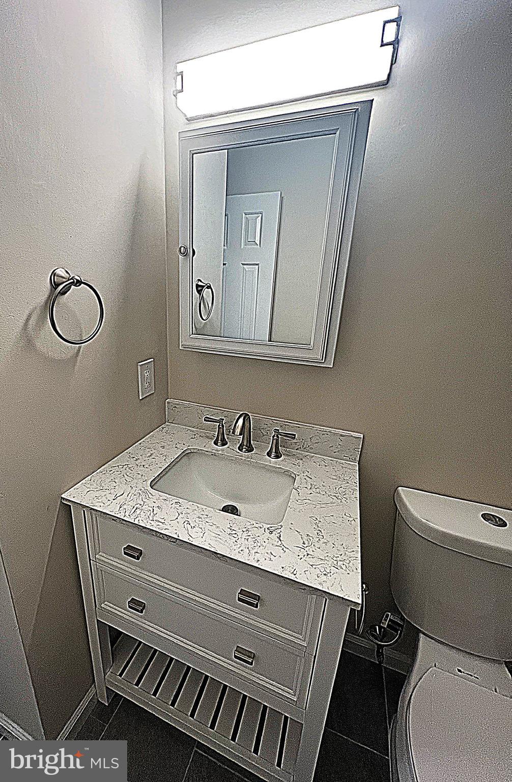 2 Washington Square Doylestown, PA 18901 - Photo 18 of 27 a bathroom with a granite countertop toilet sink and mirror