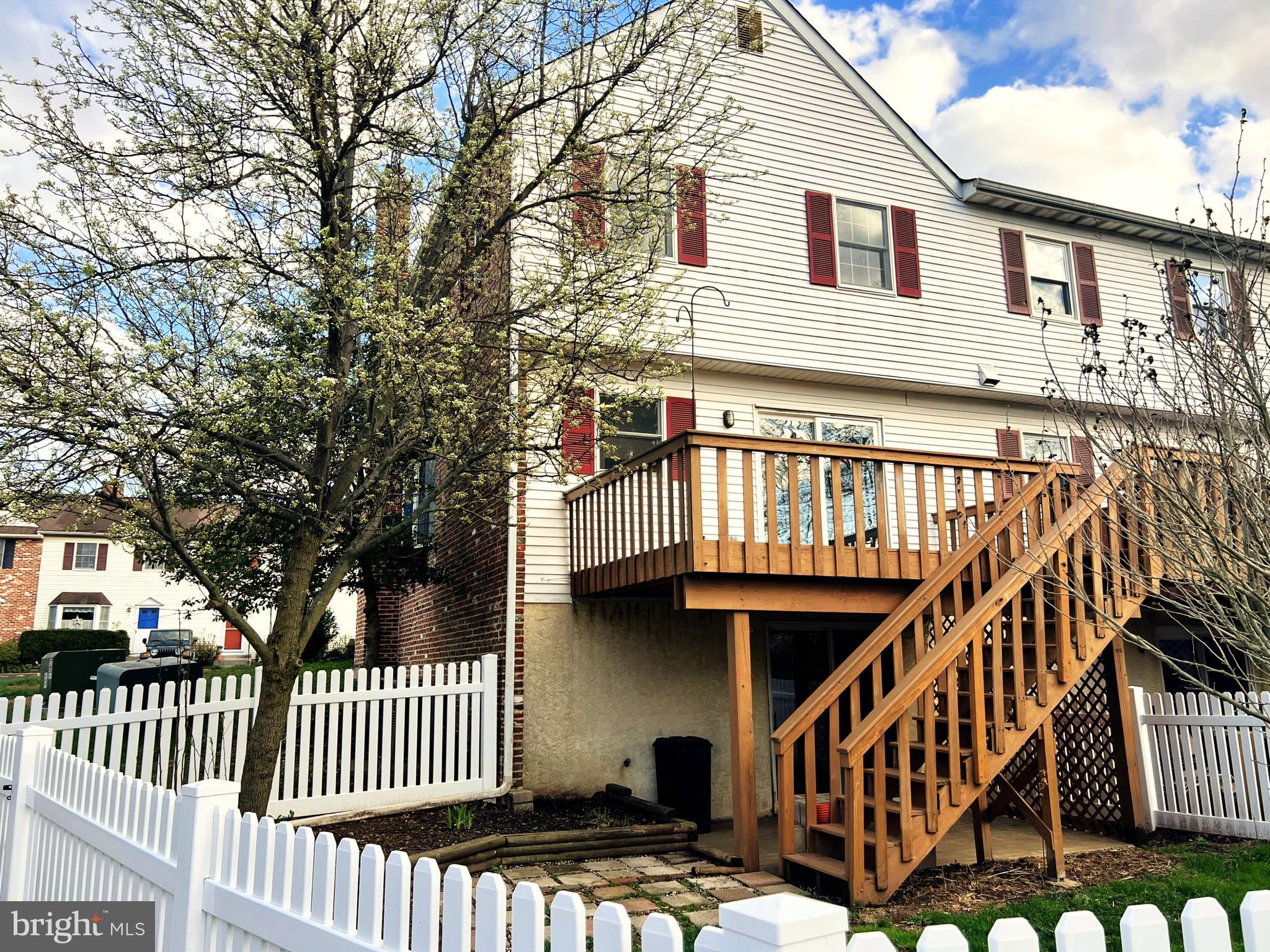 2 Washington Square Doylestown, PA 18901 - Photo 26 of 27 a view of a house with wooden deck stairs and a floor to ceiling window