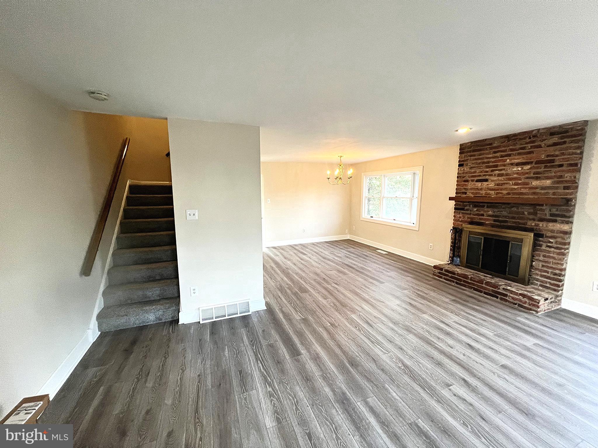 2 Washington Square Doylestown, PA 18901 - Photo 4 of 27 a view of an empty room with wooden floor fireplace and a window