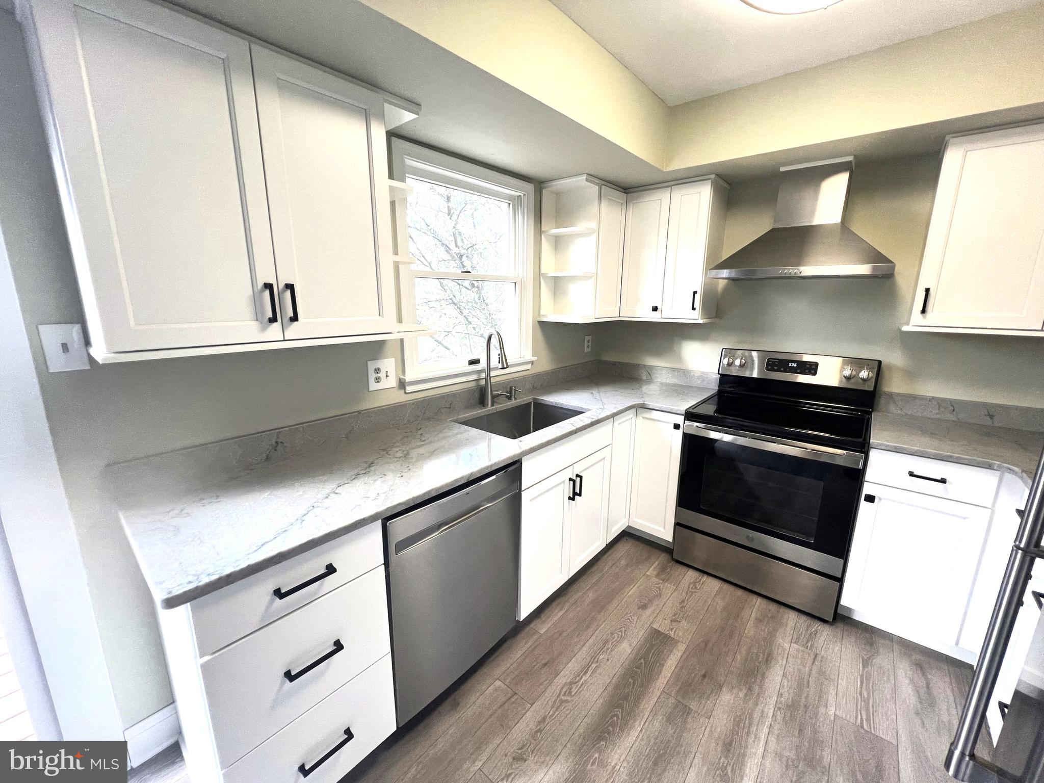 2 Washington Square Doylestown, PA 18901 - Photo 8 of 27 a kitchen with granite countertop white cabinets and white appliances