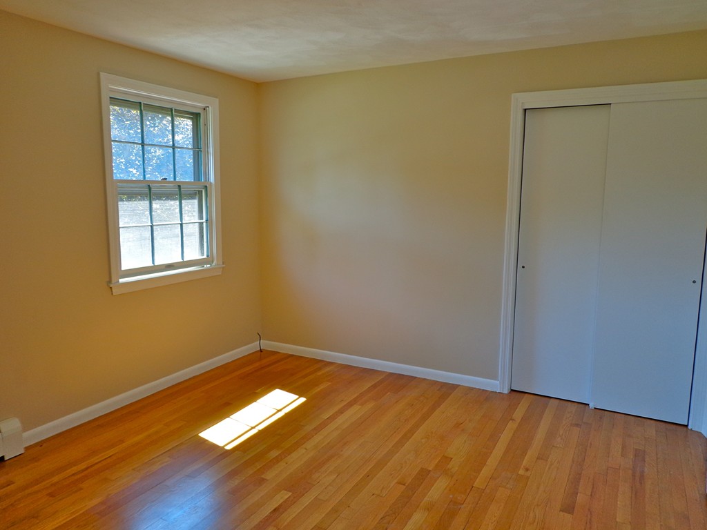 16 Juniper Lane Rutland, MA 01543 - Photo 13 of 22 a view of empty room with wooden floor and fan