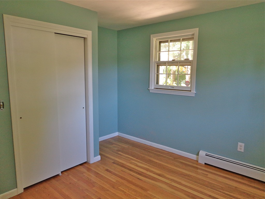 16 Juniper Lane Rutland, MA 01543 - Photo 14 of 22 an empty room with wooden floor and windows