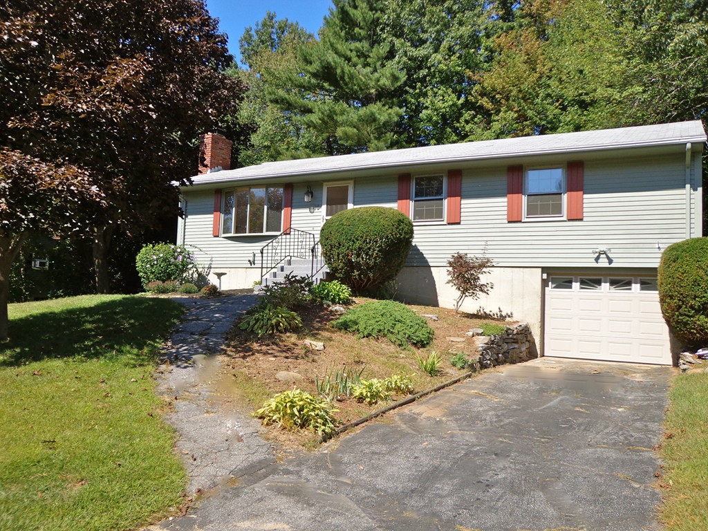 16 Juniper Lane Rutland, MA 01543 - Photo 20 of 22 a front view of a house with a yard and garage