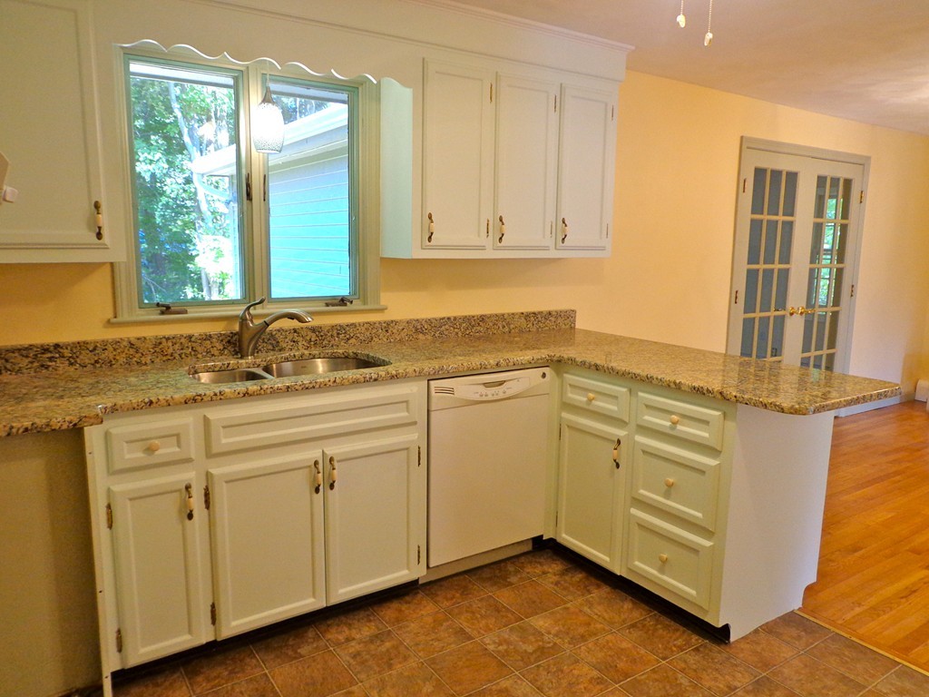 16 Juniper Lane Rutland, MA 01543 - Photo 2 of 22 a kitchen with granite countertop white cabinets and white appliances