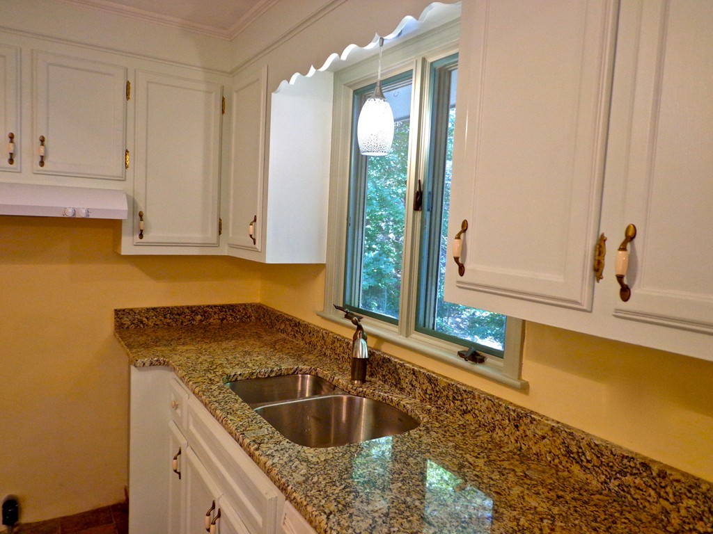 16 Juniper Lane Rutland, MA 01543 - Photo 5 of 22 a kitchen with granite countertop a sink and white cabinets