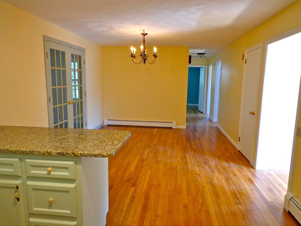 16 Juniper Lane Rutland, MA 01543 - Photo 6 of 22 a view of a livingroom with wooden floor and kitchen space