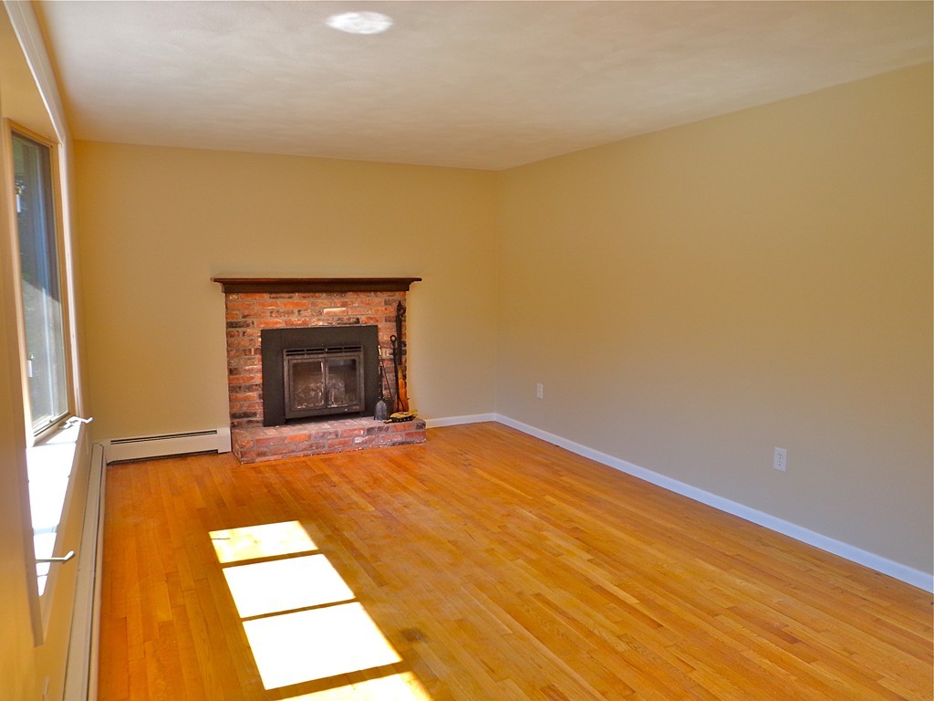 16 Juniper Lane Rutland, MA 01543 - Photo 9 of 22 wooden floor in an empty room with a fireplace