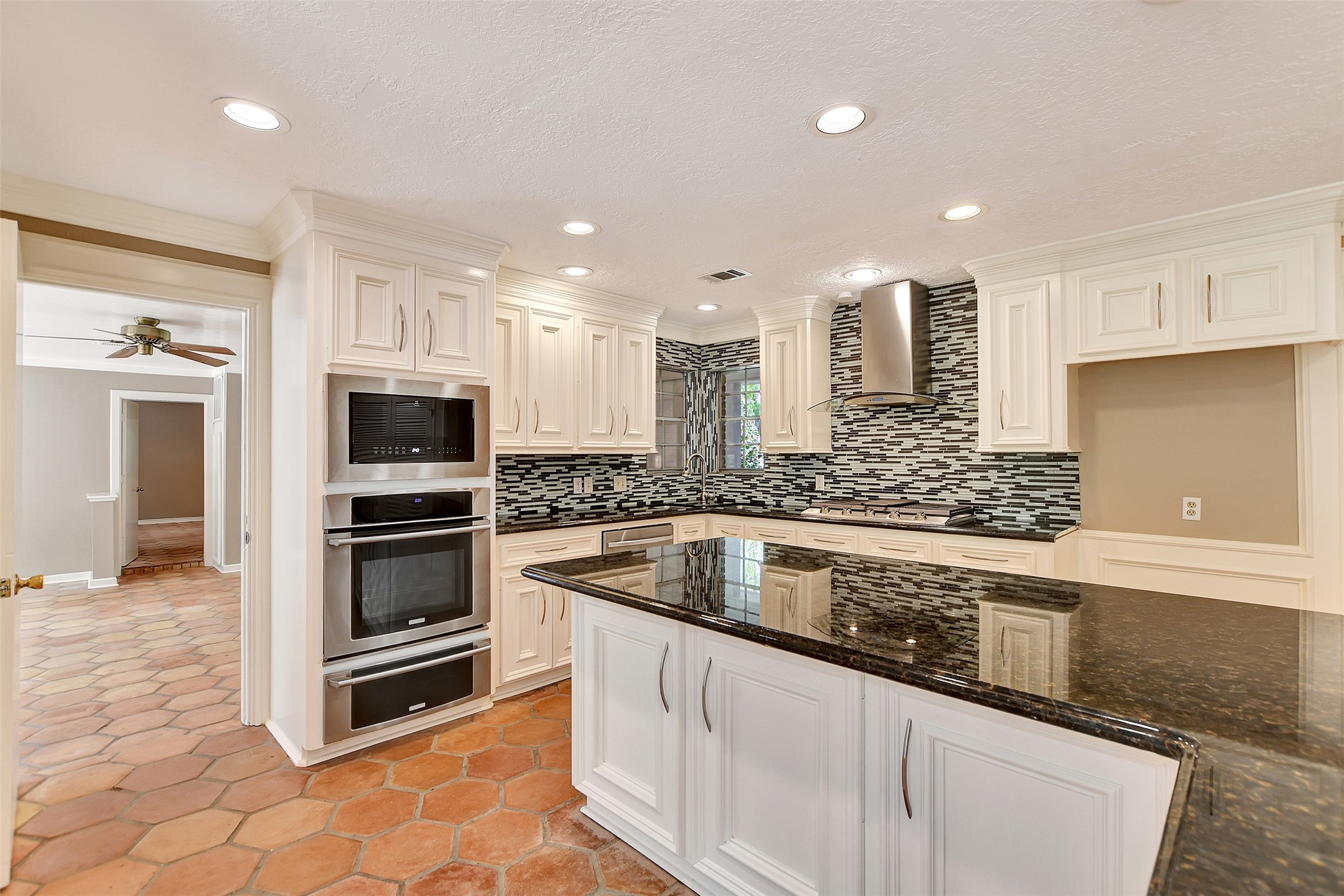 16002 Koenig Lane Conroe, TX 77384 - Photo 15 of 48 a kitchen with stainless steel appliances kitchen island granite countertop a sink and cabinets