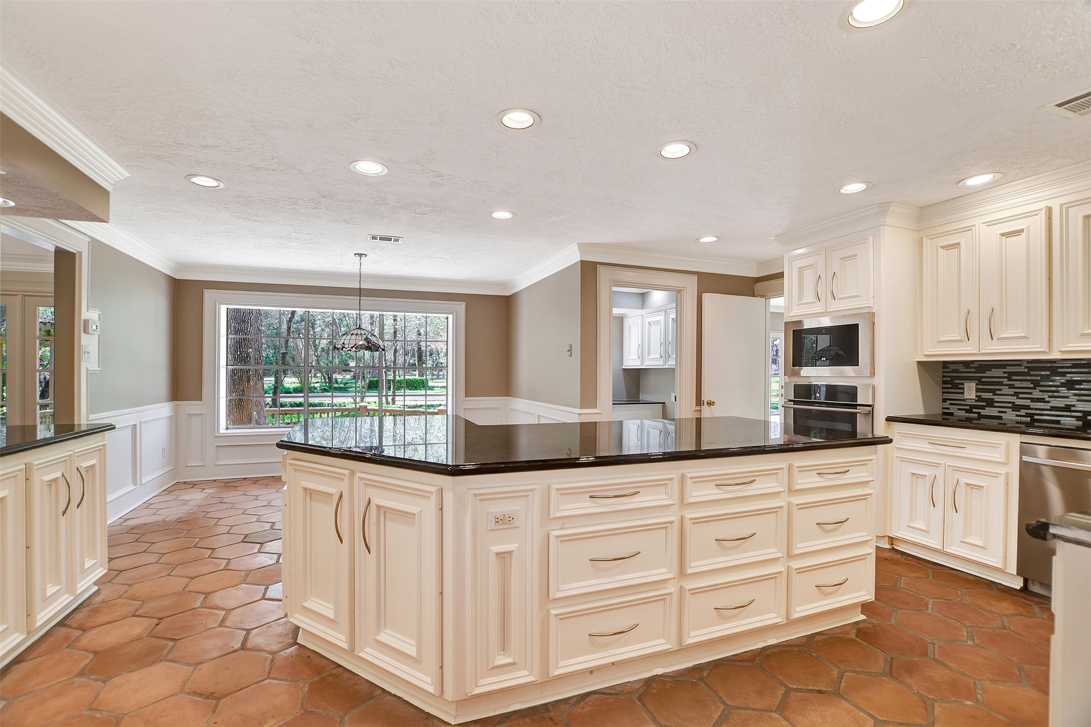 16002 Koenig Lane Conroe, TX 77384 - Photo 16 of 48 a large kitchen with granite countertop a large window and white stainless steel appliances