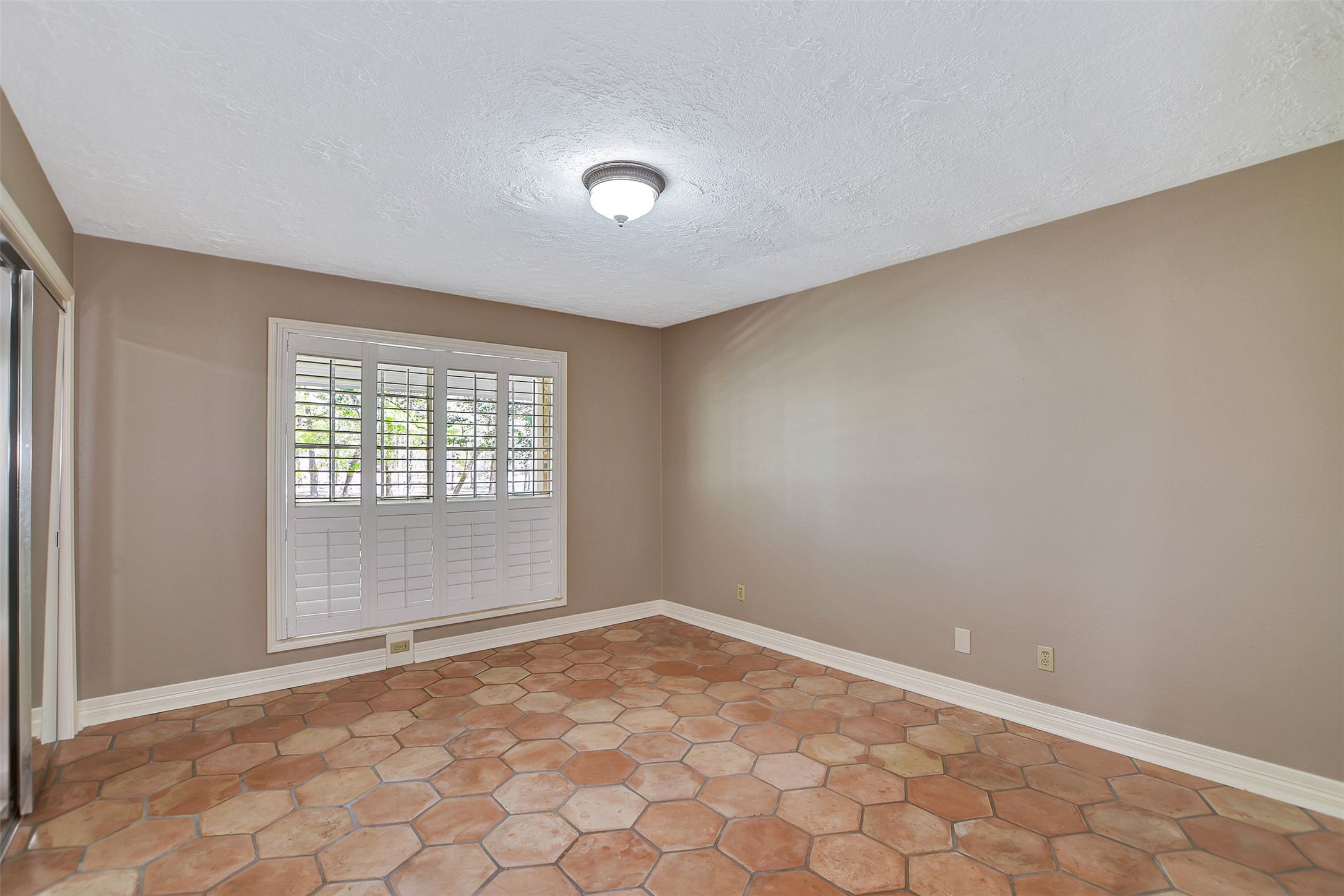 16002 Koenig Lane Conroe, TX 77384 - Photo 28 of 48 an empty room with white walls and sliding door