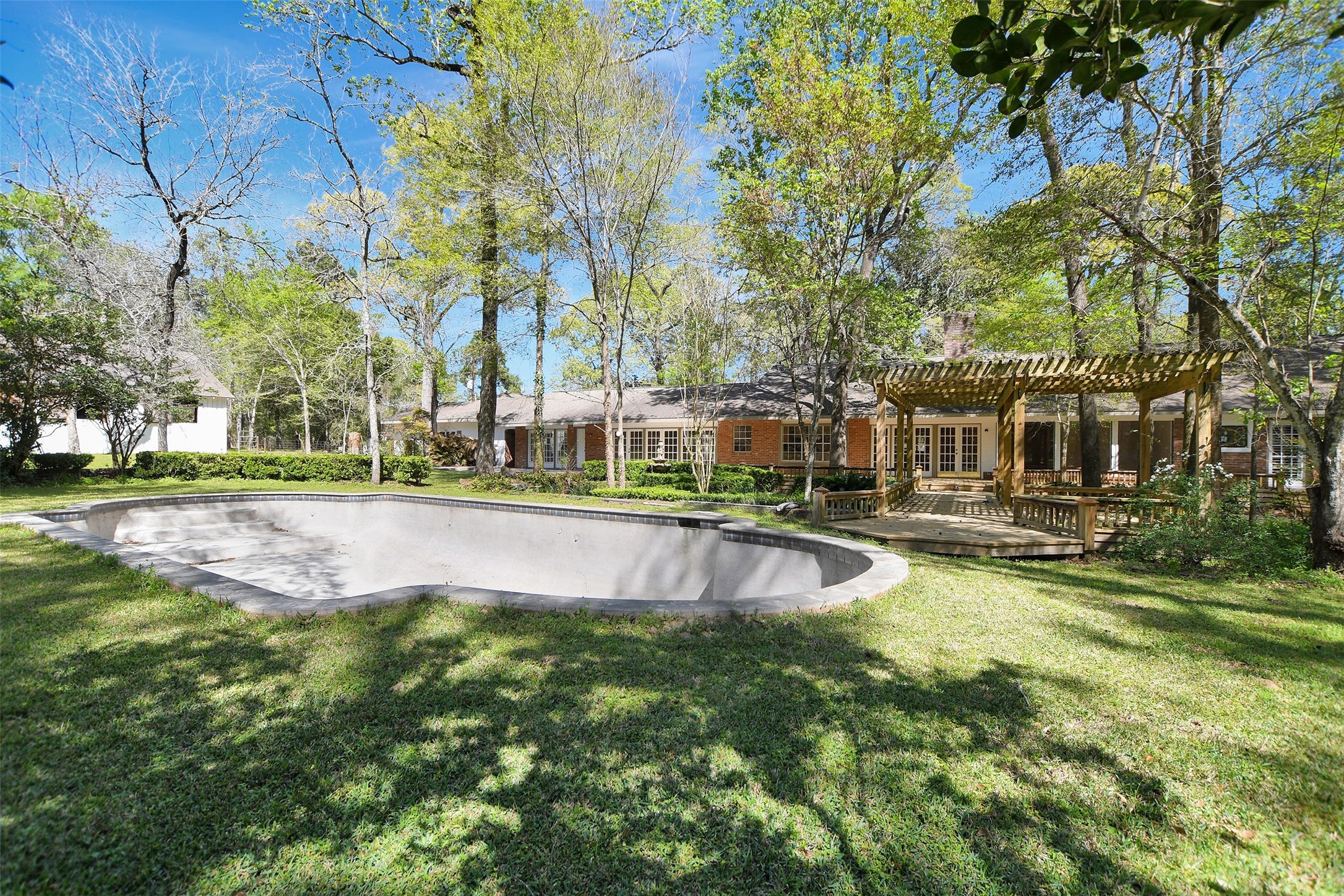 16002 Koenig Lane Conroe, TX 77384 - Photo 38 of 48 a view of pool with lawn chairs and large trees
