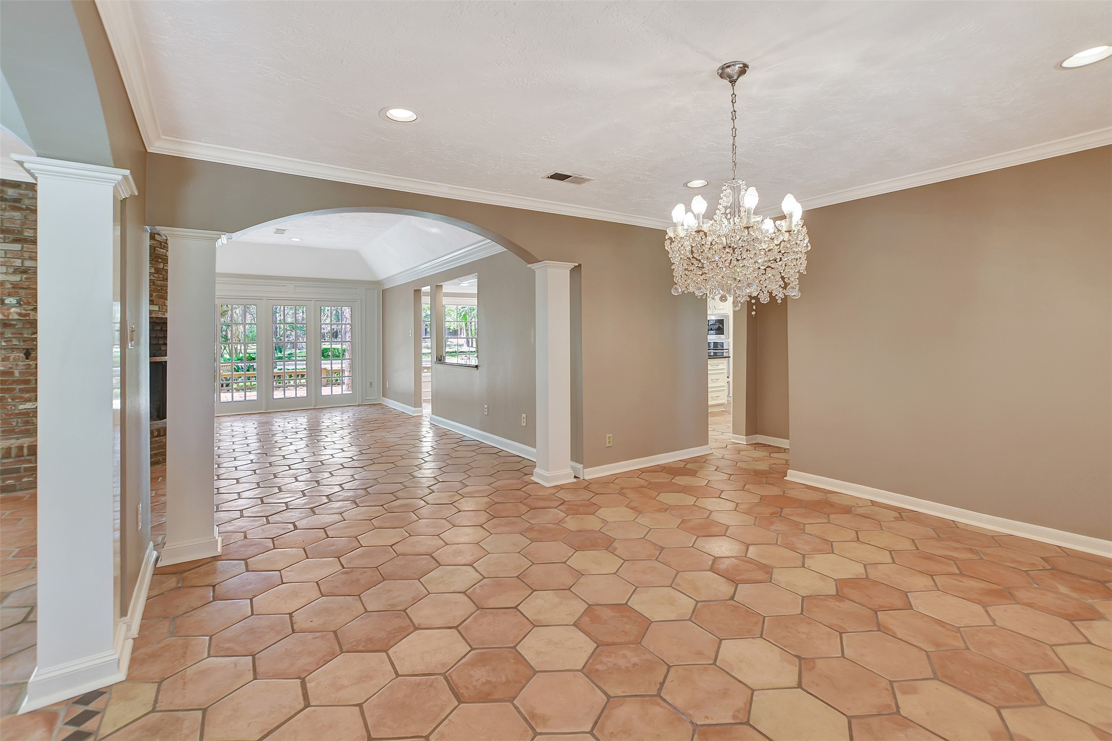 16002 Koenig Lane Conroe, TX 77384 - Photo 9 of 48 a view of a hallway with chandelier and glass door