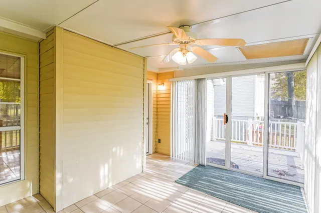 a view of a room with wooden floor and windows