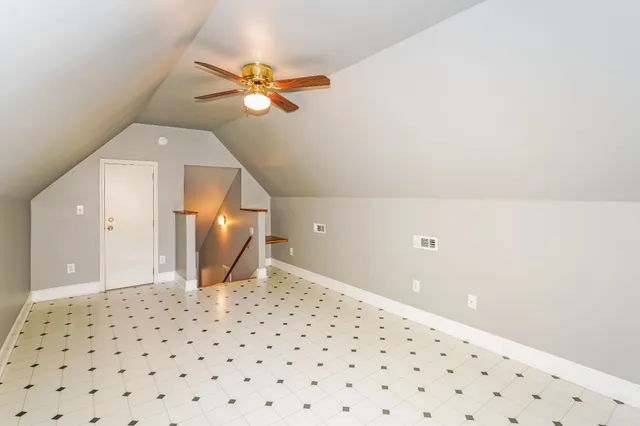 a view of a hallway with a chandelier fan and wooden floor
