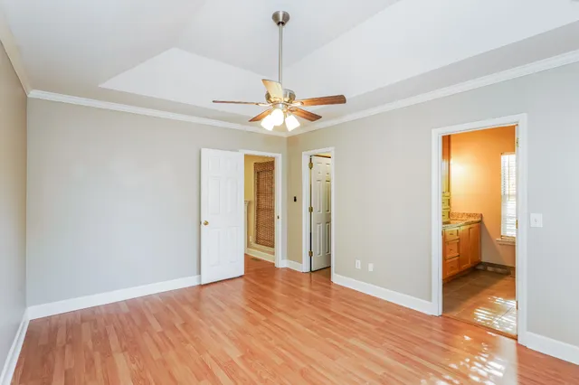 a view of a livingroom with a chandelier & a ceiling fan