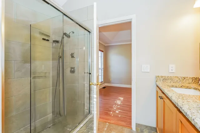 a bathroom with a granite countertop shower mirror and a sink