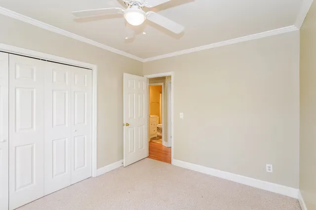 an empty room with a ceiling fan and a window