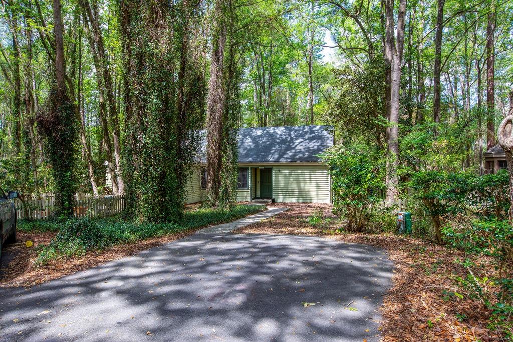 5208 Southwest 86 Terrace Gainesville, FL 32608 - Photo 2 of 26 a view of a house with backyard and trees
