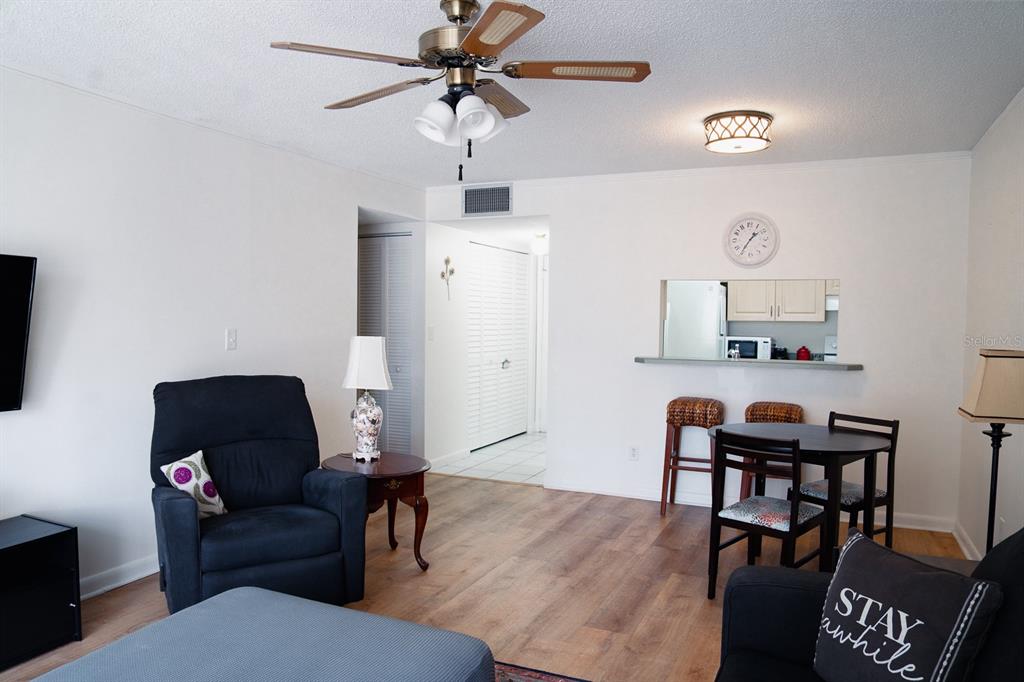 519 Albee Farm Road, Unit 110 Venice, FL 34285 - Photo 22 of 33 a living room with furniture and a flat screen tv