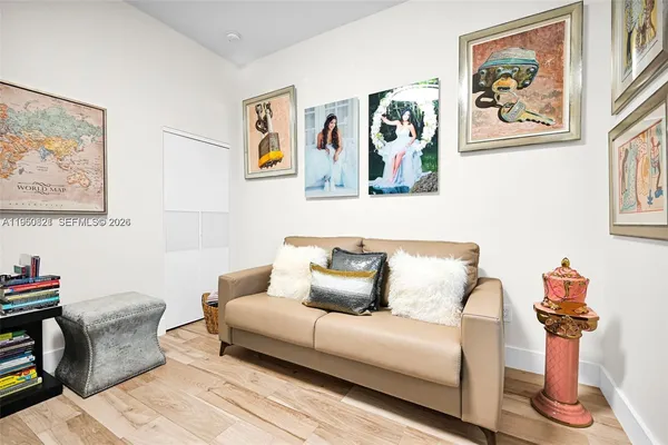 a living room with a balcony and furniture