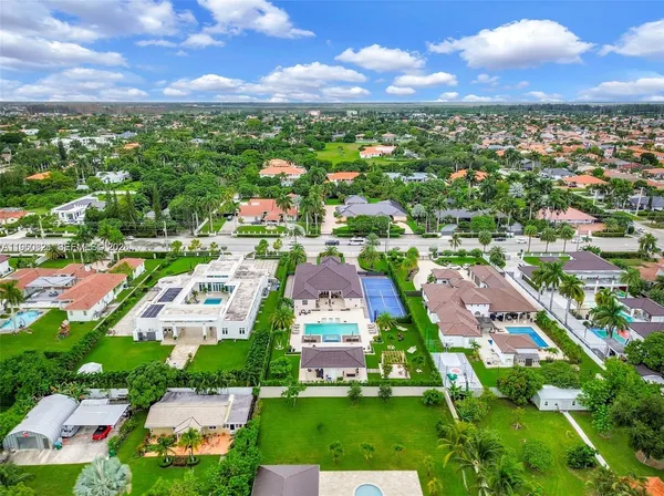an aerial view of multiple houses with yard
