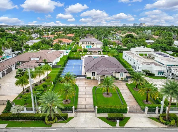 an aerial view of residential houses with outdoor space and ocean view