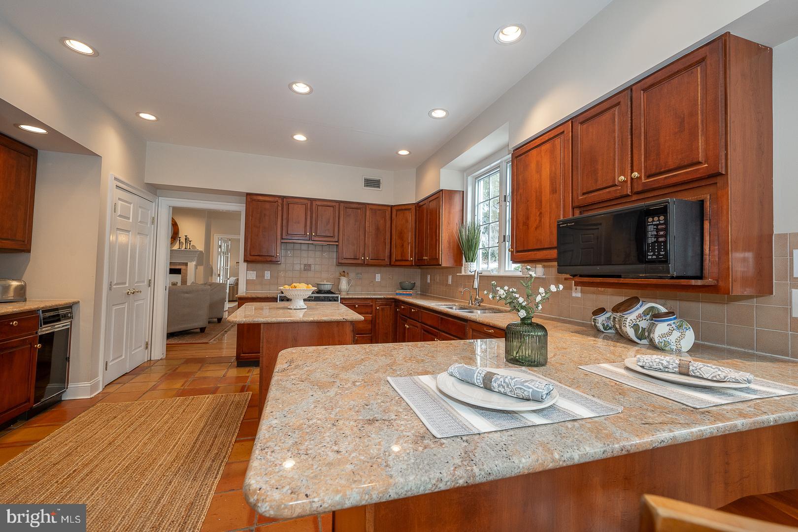 400 Orchard Way Wayne, PA 19087 - Photo 16 of 60 a large kitchen with stainless steel appliances granite countertop a lot of counter space and wooden floor