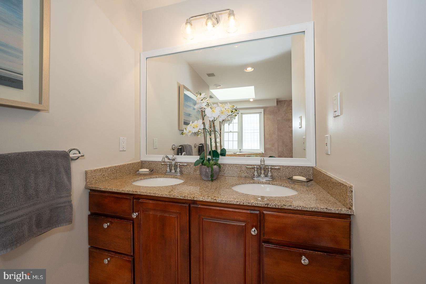 400 Orchard Way Wayne, PA 19087 - Photo 34 of 60 a bathroom with a granite countertop sink and a mirror