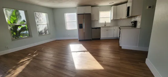 a kitchen with refrigerator and window