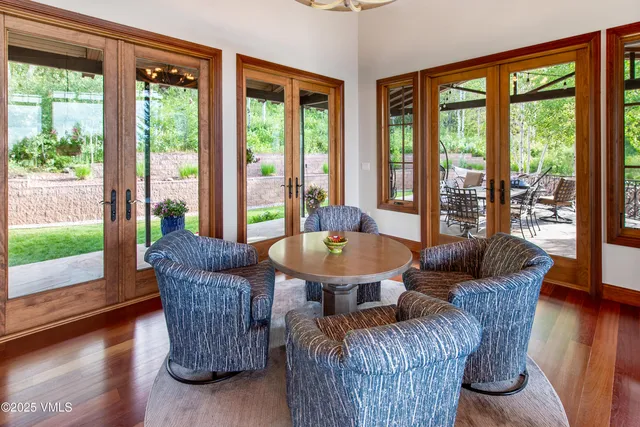 a living room with furniture and a floor to ceiling window