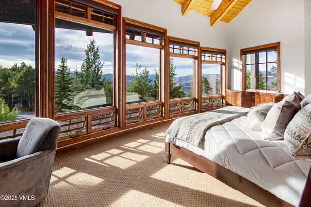 a bedroom with a bed and glass window