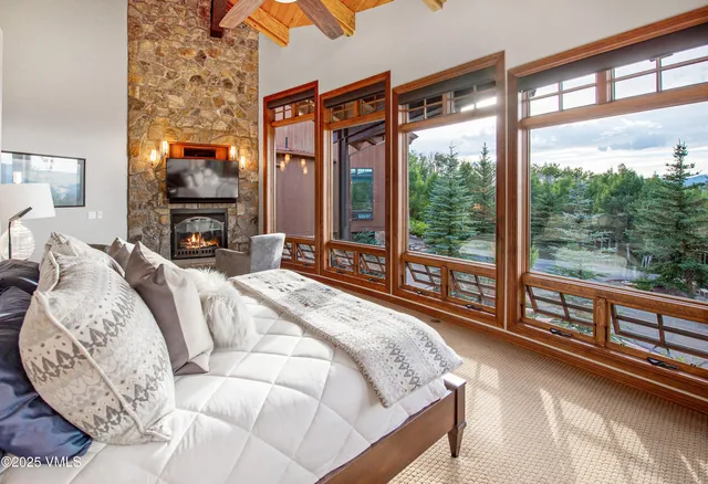 a bed sitting in a bedroom next to a large window