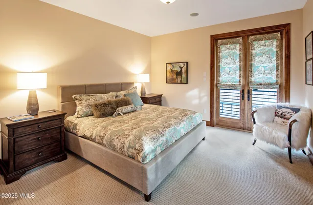 a bedroom with a bed and a chair