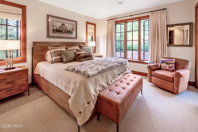 a spacious bedroom with a bed and a couch