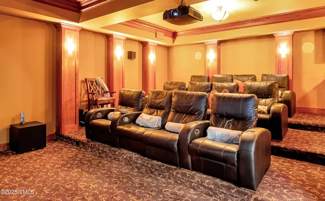 a media room with lots of chairs and a projector