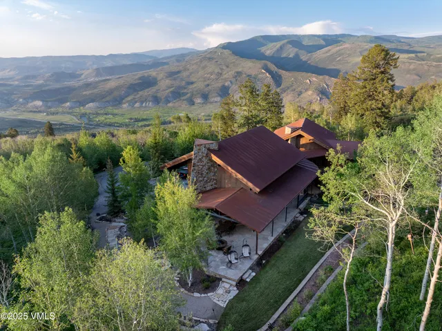 an aerial view of houses with a yard