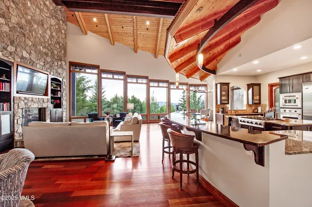 a living room with furniture appliances and a large window