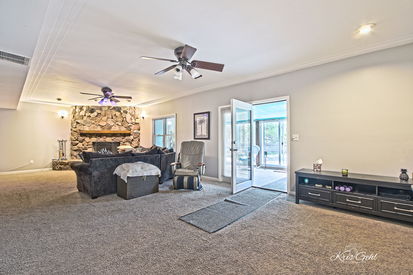 Undisclosed Address Lindenhurst, IL 60046 - Photo 21 of 32 a living room with furniture a chandelier and a flat screen tv