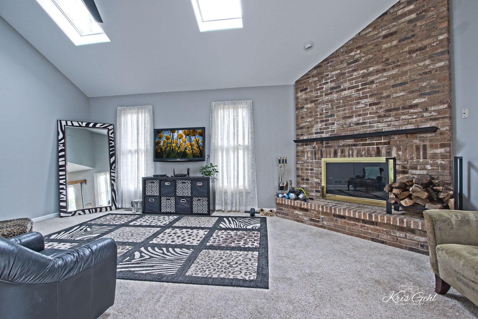 Undisclosed Address Lindenhurst, IL 60046 - Photo 8 of 32 a living room with furniture a flat screen tv and a fireplace