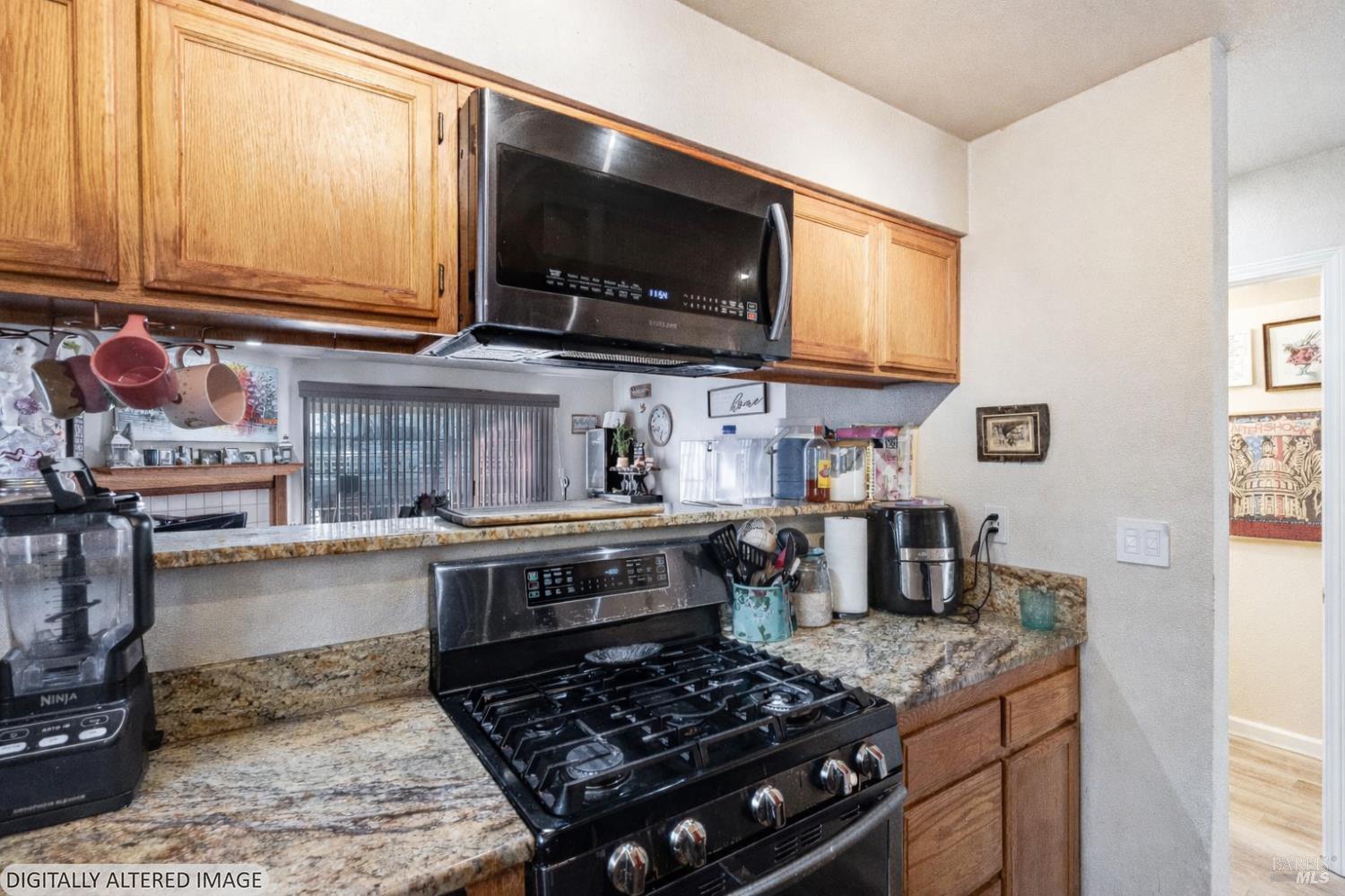 590 Laurel Grove Circle Santa Rosa, CA 95407 - Photo 12 of 44 a kitchen with stainless steel appliances granite countertop a stove and a microwave