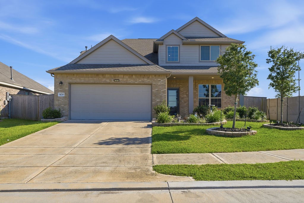 a front view of a house with a yard and garage