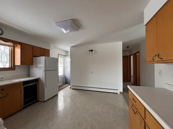 a kitchen with stainless steel appliances a refrigerator and a stove