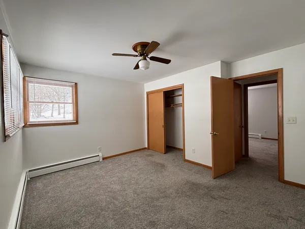 a view of a livingroom with a ceiling fan and entryway