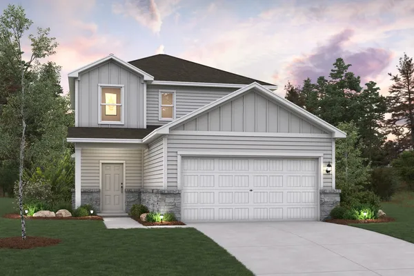 a front view of a house with a garden and garage
