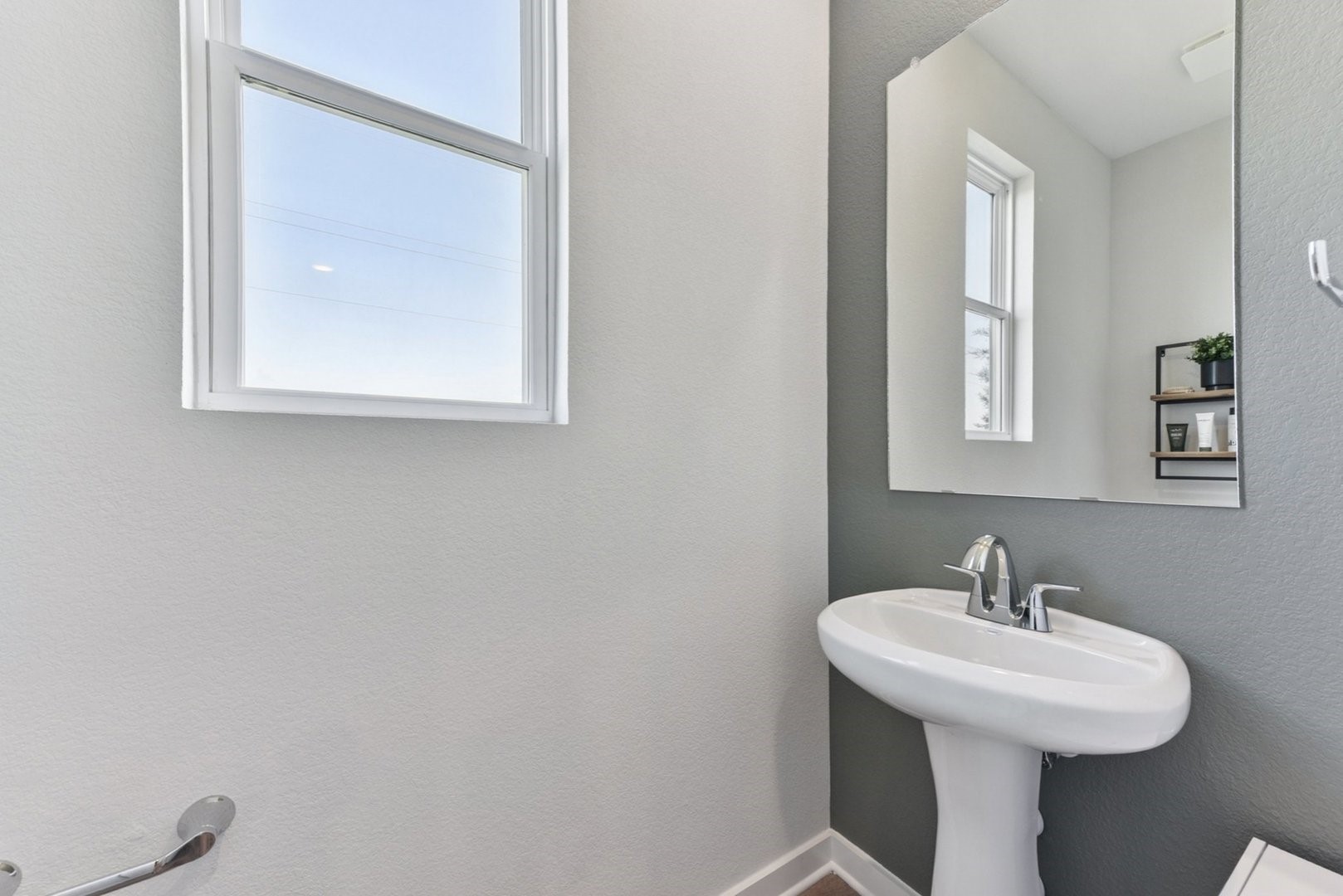 233 Escape Way Jarrell, TX 76537 - Photo 17 of 22 a bathroom with a sink a mirror and a window