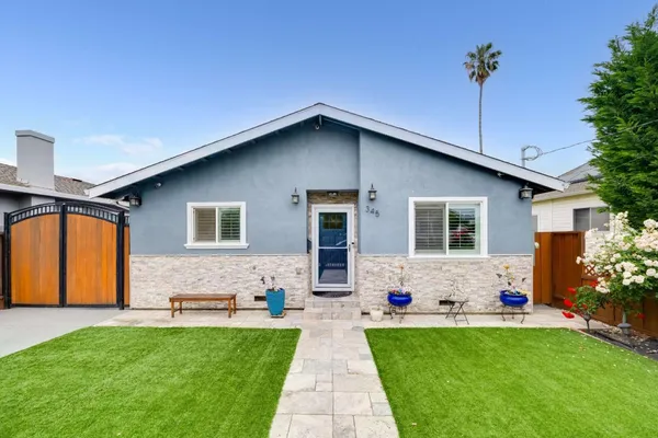 a front view of house with yard and outdoor seating