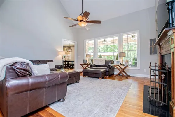 a living room with furniture and wooden floor