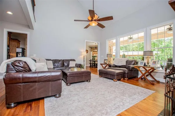 a kitchen with stainless steel appliances white cabinets and wooden floors